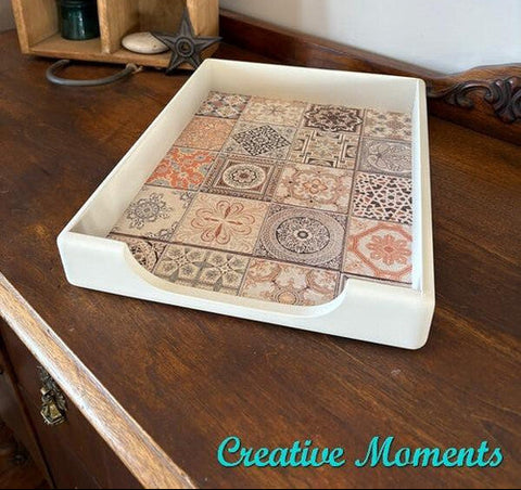 Decorative tray with patterned design on a wooden surface, with 'Creative Moments' branding.
