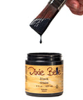Dixie Belle Black Glaze jar with a brush dripping the glaze.