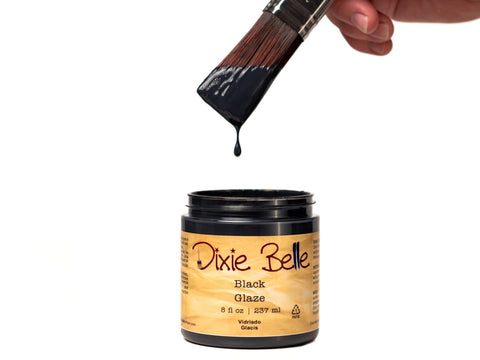 Dixie Belle Black Glaze jar with a brush dripping the glaze.