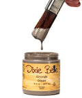 Dixie Belle Grunge Glaze can with a brush dipping into it on a white background