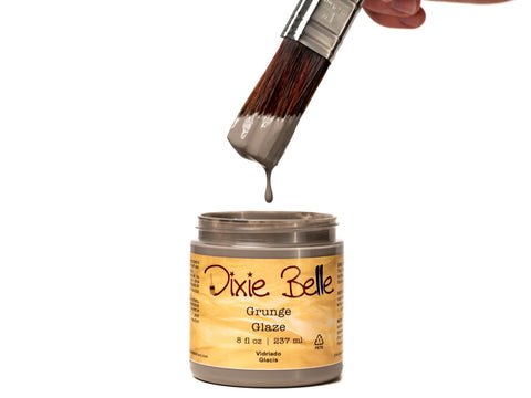 Dixie Belle Grunge Glaze can with a brush dipping into it on a white background