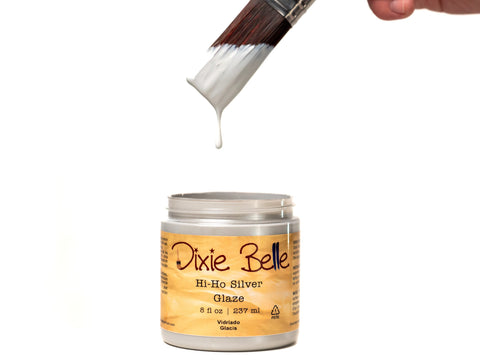 Dixie Belle Hi-Ho Silver Glaze with a brush dipping into it on a white background