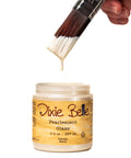Dixie Belle Pearlescent Glaze jar with a brush dipping into it on a white background
