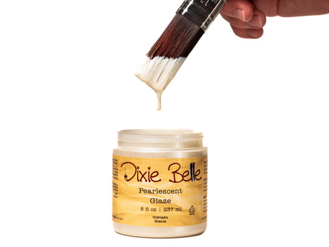 Dixie Belle Pearlescent Glaze jar with a brush dipping into it on a white background