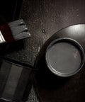 Iron metallic paint can with a brush on a dark surface