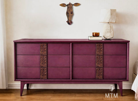 Purple dresser with decorative elements in a room setting