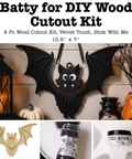 Halloween DIY wood cutout kit featuring a bat-shaped ornament. The main image shows the black bat cutout hanging on a wall with pumpkins and lanterns around it.