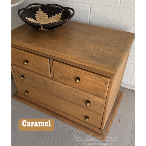 Wooden dresser with three drawers and a woven basket on top, labeled 'Caramel'.