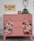 Pink dresser with floral design in a room setting with decor elements. Labeled "Mix of Cottage Door and Tea Rose."