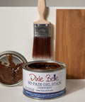 Can of Dixie Belle Chestnut No Pain Gel Stain with a brush and wood sample on a white background