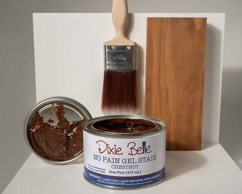 Can of Dixie Belle Chestnut No Pain Gel Stain with a brush and wood sample on a white background