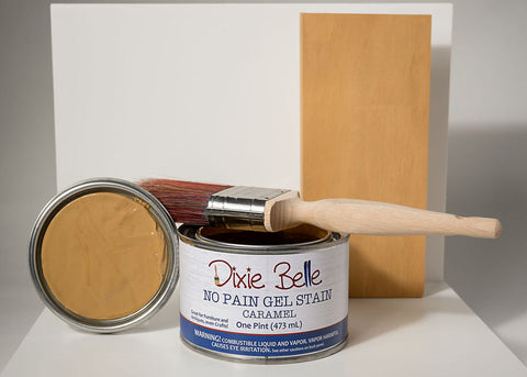 Dixie Belle Caramel No Pain Gel Stain can with applicator and wooden board on gray background