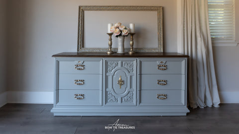 Gray dresser with decorative elements in a room setting
