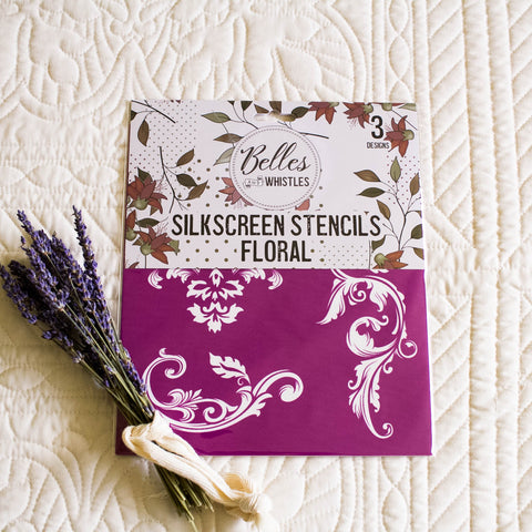 Silkscreen stencils with floral design on a textured white surface