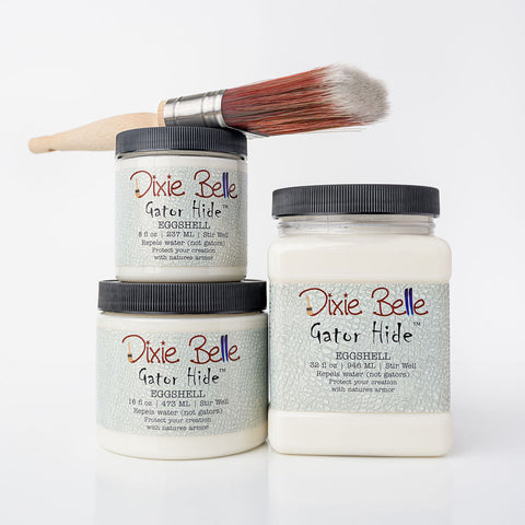 Three jars of Dixie Belle Eggshell Gator Hides with a brush on a white background