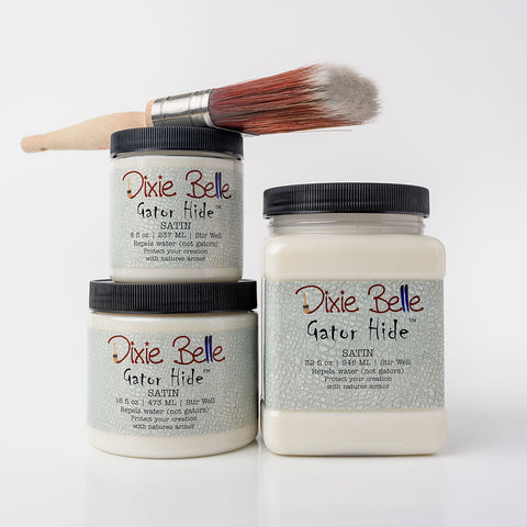 Three jars of Dixie Belle Satin Gator Hide with a brush on a white background