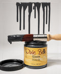 Dixie Belle Glaze Black can with a brush dripping black glaze on a white background