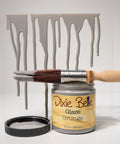Dixie Belle Glaze Grunge paint can with a brush and dripped paint effect on a white background