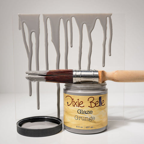 Dixie Belle Glaze Grunge paint can with a brush and dripped paint effect on a white background