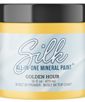 A jar of Silk All-In-One Mineral Paint in the shade Golden Hour, featuring a light yellow paint jar with a black lid and a light blue label.