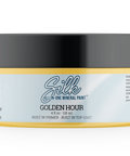 A jar of Silk Golden Hour Mineral Paint, 4 fl oz, featuring a black lid, a light blue and yellow label, and a yellow base, shown on a white background.