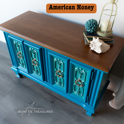 Blue cabinet with wooden top on a gray floor, featuring 'American Honey' text.
