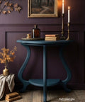 Blue side table with decorative items against a dark purple wall, featuring the brand 'Faff designs'.