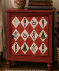 A red wooden cabinet with a holiday-themed diamond pattern on the door, styled in a cozy room setting with books and a ceramic vase on top.