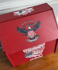 Red box with military-themed design on a wooden surface