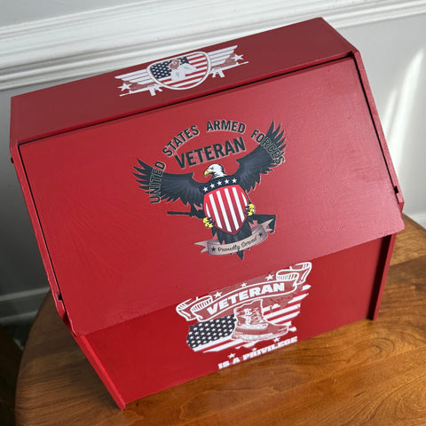 Red box with military-themed design on a wooden surface