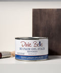 Dixie Belle Espresso No Pain Gel Stain can with a brush and color swatch on a gray background