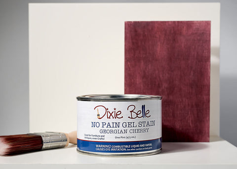 Can of Georgian Cherry Dixie Belle gel stain with a brush and swatch on a gray background