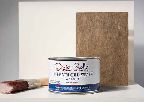 Dixie Belle Walnut gel stain can with a brush and wood sample on a gray background