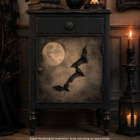 A dark vintage-style cabinet or nightstand with a distressed black finish, featuring a door panel decorated with a full moon and three silhouetted bats. The cabinet stands in a dimly lit room with candles and wood paneling in the background.
