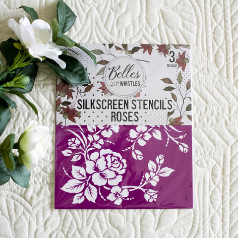 Roses Silkscreen stencils by Belles & Whistles on a textured white surface with flowers.