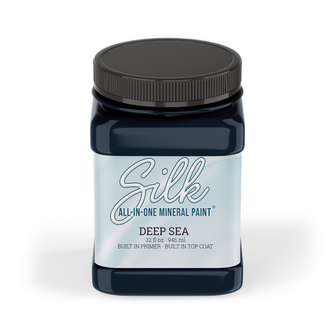 A 32 oz. jar of Silk All-In-One Mineral Paint in the color Deep Sea, featuring a dark blue body, a black lid, and a light blue and white label.