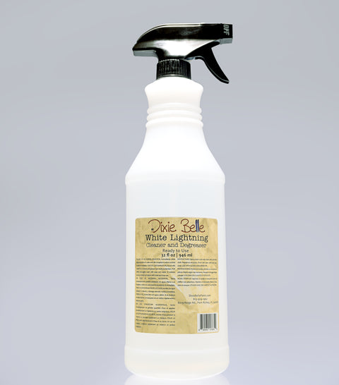 32 oz. white spray bottle with black nozzle on a gray background