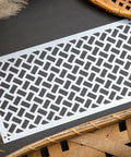 Belles and Whistles Basket Weave -  A Basket Weave design on our Premium Mylar Stencils feature a high grade material allowing for the most precise stenciling techniques and applications. Our stencils can be used on walls, furniture and more. Durable and reusable.  Laser cut on 1o mil Mylar.
Image of Basket Weave - Stencil laid out on a black background with woven baskets and feathers staged around.