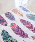 Belles and Whistles Feathers - Rice Decoupage Paper is a simple way to visually enhance any surface of your project!
This shows a picture of feathers decoupage laid out on a shiny, white surface.  There are many multicolored feathers ready to be cut out and decoupaged onto your favorite piece of furniture of glass jar.