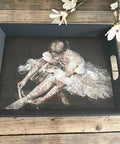Belles and Whistles Floral Ballerina - A1 Rice Decoupage Paper is a simple way to visually enhance any surface of your project!
A black tray with Floral Ballerina - A1 Rice Decoupage Paper  in the center. Staged on a rustic wood background.