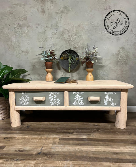 Belles and Whistles Locally Grown - Stencil provides an extra decorative touch to any project! Natural log driftwood table with green paint on the drawer fronts and wooden handles. "Dill" and "Thyme" have been applied in white paint with their corresponding herb stencil on the left drawer front. "Parsley" and "Rosemary" have been applied with their corresponding herb stencil on the right drawer front.