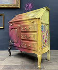 Belles and Whistles Mudcloth - Stencil provides an extra decorative touch to any project! Rainbow secretary desk with stencil on the doors and flowers on the side.