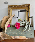 Belles and Whistles Nailhead Trim - Stencil provides an extra decorative touch to any project! Green Chalk Painted wood tool box with Nailhead trim stencil painted on. Staged with a cowboy hat, some plants and a piece of wood.