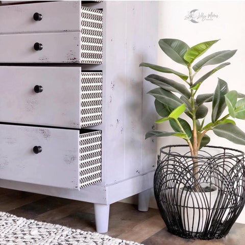 Belles and Whistles Patterns - Silkscreen Stencil provides an extra decorative touch to any project! Side of dresser painted lavender chalk paint with black painted pattern stencil on the side of the drawers.