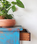 Belles and Whistles Patterns - Silkscreen Stencil provides an extra decorative touch to any project! Blue chalk painted end table with rainbow pattern stencil painted on the side of the drawers.