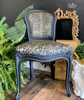 Belles and Whistles Safari - Stencil provides an extra decorative touch to any project! A black painted chair featuring the cheetah stencil on the seat part and the zebra stencil on the back of the chair, all in gold.
