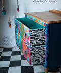 Belles and Whistles Safari - Stencil provides an extra decorative touch to any project! A bedside table that has water color all over and the drawer side is shown with the zebra print, contrasting well with the colors.