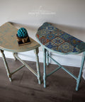 Belles and Whistles Sonoma Art Tile - Stencil provides an extra decorative touch to any project! 2 half-moon hallway tables, one with a washed top with the sonoma art tile stencil on the top in blue and the legs are painted in blue. The second table has a Mediterranean table top  and blue legs as well.