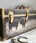 Belles and Whistles Tatanka - A1 Rice Decoupage Paper is a simple way to visually enhance any surface of your project! Large chest with leather on the edges and gold hinges and clasps. The Tatanka Rice Decoupage Paper has been applied on the front of the chest. There is newspaper clippings on the floor in front of the chest along with a rusty horseshoe.
