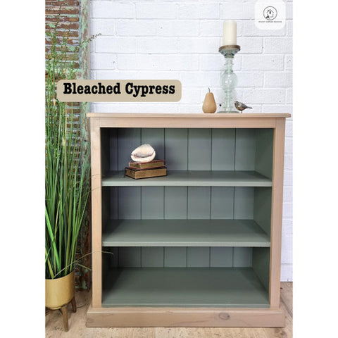 Bookshelf with 'Bleached Cypress' finish against a white brick wall.